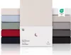 A stack of fitted sheets in various colors, with a product box in the foreground. Anteprima dell’immagine prodotto
