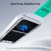 A close-up view of a phone screen protector being applied using an applicator tool. Náhľad obrázku produktu