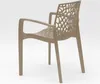 A single beige chair with an intricate, web-like design on the back and seat, shown from a side-rear angle against a white background. Produktbild-Vorschau