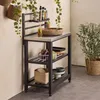 A kitchen shelving unit with various items on it, including a bowl of salad, bottles of oil and spices, and some vegetables. Anteprima dell’immagine prodotto