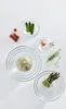 A collection of glass bowls containing various fresh ingredients, arranged on a white surface. Anteprima dell’immagine prodotto