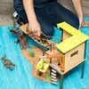 A child is playing with a toy wildlife adventure station on a blue rug. Anteprima dell’immagine prodotto