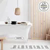 A table covered with a white tablecloth, set with plates and bottles, in a room with wooden slatted dividers and a pendant lamp. Produktbild-Vorschau