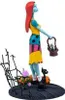 A collectible figure of Sally from The Nightmare Before Christmas, standing on a decorative base with a black cat and pumpkins. Podgląd zdjęcia produktu