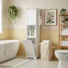 A bathroom with a bathtub, toilet, and storage cabinet. Voir les images du produit