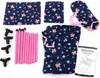 The image displays the components of a foldable doll travel bed, including fabric pieces with a floral pattern, pink support poles, black connectors, and an instruction manual. Produktbild-Vorschau