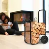 A couple is relaxing by a fireplace, using a tablet, with a log cart nearby. Anteprima dell’immagine prodotto