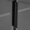 A close-up view of a black handle on a glass cabinet. Náhľad obrázku produktu