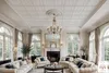 A luxurious living room with white sofas, a fireplace, and large arched windows. Produktbild-Vorschau