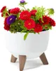 A white planter with wooden legs holding a bouquet of colorful flowers. Náhled obrázku produktu
