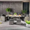 An outdoor patio setting with a polyrattan lounge furniture set arranged around a coffee table. Náhled obrázku produktu