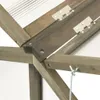 A close-up view of the wooden frame and transparent panels of a greenhouse, showing the construction details and hinges. Produktbild-Vorschau