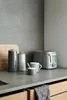 A modern kitchen counter with a toaster, canisters, and a mug. Anteprima dell’immagine prodotto