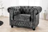 A grey Chesterfield armchair is shown in a well-lit room with a wooden floor. Produktbild-Vorschau