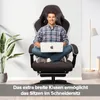 A man sits cross-legged in a gaming chair while using a laptop. A plant is visible on the left, and a floor lamp on the right. Produktbild-Vorschau