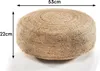 A round, woven pouf is shown against a white background with dimensions indicated by arrows and text. Produktbild-Vorschau