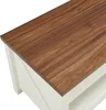 Close-up view of the corner of a coffee table with a wood-grain top and white base. Náhled obrázku produktu