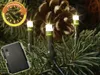 LED lights on a Christmas tree branch with a pine cone in the background. Produktbild-Vorschau