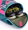 A close-up view of a floral-patterned sports bag with a pair of athletic shoes inside. Podgląd zdjęcia produktu