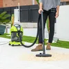 A person is using a wet and dry vacuum cleaner outdoors on a paved patio. Anteprima dell’immagine prodotto