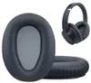 A close-up of headphone ear pads and a pair of headphones. Produktbild-Vorschau