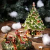 Christmas decorations on a wooden table with a Christmas tree in the background. Náhľad obrázku produktu