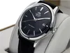 A close-up shot of an Orient Bambino watch with a black dial and a black leather strap, displayed on a white stand. Produktbild-Vorschau