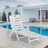 A white plastic lounge chair is placed on a wooden deck next to a swimming pool, with a modern house and patio in the background. Voir les images du produit