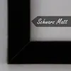 A close-up view of a black picture frame corner with a dark gray banner overlay containing text. Produktbild-Vorschau