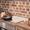 A kitchen counter with a stovetop, backsplash, and various cooking ingredients. Náhľad obrázku produktu