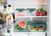 Inside a refrigerator, showing food storage containers and produce. Produktbild-Vorschau