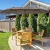 A patio set with a large umbrella in a backyard setting. Náhľad obrázku produktu