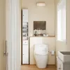 A clean and modern bathroom with a tall white cabinet next to a toilet. Náhled obrázku produktu