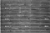 A top-down view of a modular storage system made of dark gray plastic. Náhled obrázku produktu