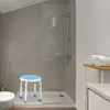 A shower stool is placed in a modern bathroom next to a toilet and shower. Produktbild-Vorschau