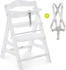 A white high chair with a safety harness accessory shown next to it. Produktbild-Vorschau