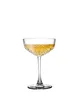 A champagne coupe glass filled with a golden beverage, set against a plain white background. Náhled obrázku produktu