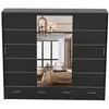 A black sliding door wardrobe with a large mirror in the center, reflecting a bedroom interior. Produktbild-Vorschau