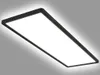 A rectangular LED panel light with a black frame, mounted on a light gray wall. Anteprima dell’immagine prodotto