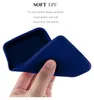 A hand is holding a flexible blue phone case, demonstrating its softness and flexibility. Produktbild-Vorschau