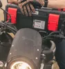 A person wearing gloves is holding a black and red toolbox attached to a motorcycle. Anteprima dell’immagine prodotto