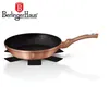 A rose gold frying pan with a black speckled interior, placed on a black star-shaped trivet. The brand logo and name are visible in the top left corner. Voir les images du produit