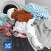 A laundry basket overflowing with clothes next to a washing machine. Produktbild-Vorschau