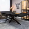 A dining room setting with a large black dining table, chairs, and a cabinet. Produktbild-Vorschau