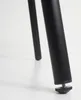 Close-up of the bottom of two black chair legs with adjustable feet. Produktbild-Vorschau