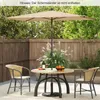 A patio set with a table, chairs, and an umbrella in a backyard setting. Podgląd zdjęcia produktu