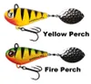 Two fishing lures are displayed against a white background. The top lure is yellow with black stripes and a red head, labeled 'Yellow Perch'. The bottom lure is yellow with green and black stripes and an orange-red head, labeled 'Fire Perch'. Both lures ha Produktbild-Vorschau