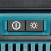 A close-up view of two buttons on a teal and black electronic device. Produktbild-Vorschau