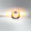 A portable work light with an orange glow sits on a reflective surface against a gradient background. Produktbild-Vorschau
