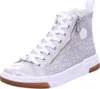 A single silver high-top sneaker with white laces and a brown sole is shown against a white background. Náhľad obrázku produktu